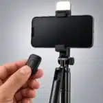 R16S Fill Light and Remote R16S phone clamp with fill light on and wireless remote in hand