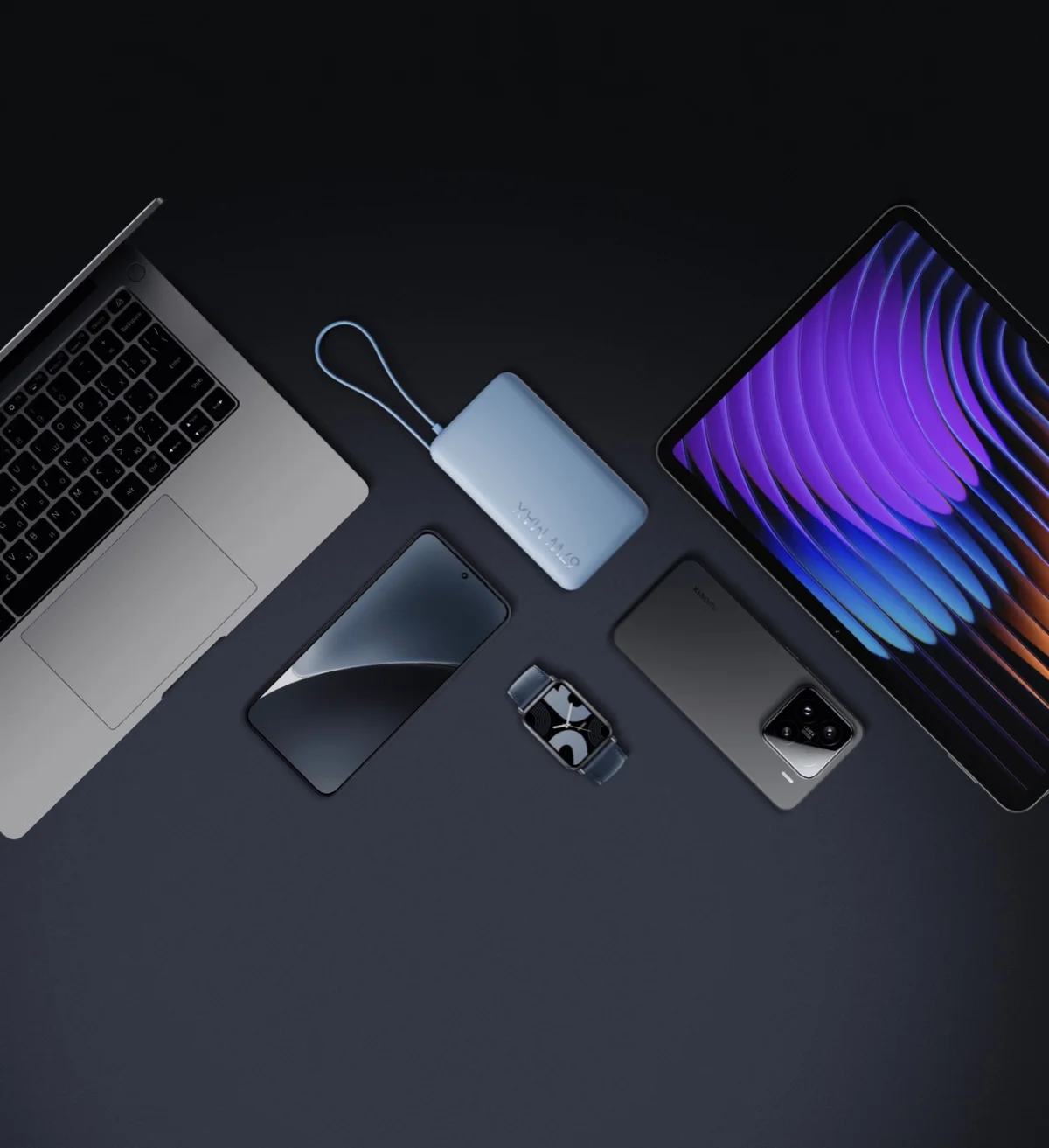 Xiaomi 67W Power Bank 10000Mah (Integrated Cable) 11 Xiaomi 67W Power Bank 10000 next to a laptop, phones, tablet and earbuds it can charge